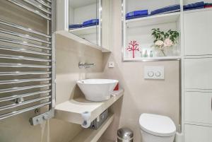 a small bathroom with a sink and a toilet at Charming 1BR Apartment In Heart Of Monaco in Monte Carlo