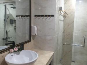 a bathroom with a white sink and a shower at SONG ANH HOTEL in Can Tho +12 photos