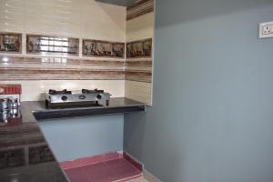a kitchen with a stove on a counter top at Malakar Home stay in Port Blair