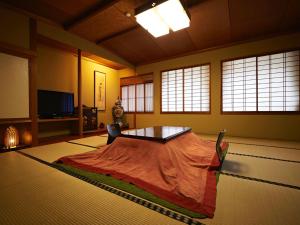 
a bed in a room with a window at Irorinoyado Ashina in Aizuwakamatsu
