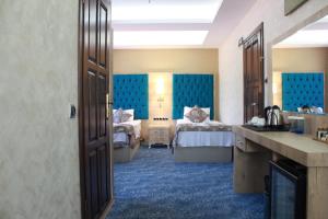 Postel nebo postele na pokoji v ubytování Ayder Hasimoglu Hotel