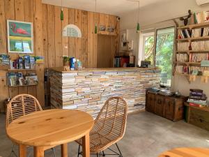 a kitchen with a table and two chairs and a counter at Hôtel Almanarre Plage - Hôtel Eco-Responsable face à la mer in Hyères