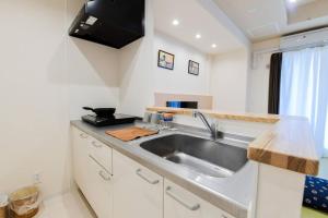 a kitchen with a sink and a counter top at momo premium 603 in Sapporo