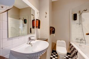 a bathroom with a sink and a toilet at Hotel-Restaurant Le Victoria in Rennes