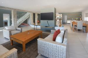 a living room with a couch and a table at 269 on Main Holiday Home in Hermanus