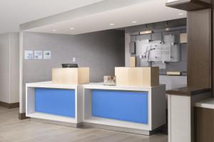 a lobby with two counters with blue lights at Holiday Inn Express Andover North - Lawrence, an IHG Hotel in Lawrence