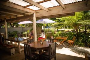 a patio with tables and umbrellas and people sitting at tables at Beletage in Knysna