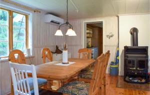a dining room with a wooden table and a stove at Stunning Home In Vstervik With Kitchen in Västervik