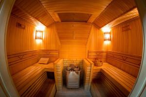 an inside view of a sauna with wooden walls at Crona Hotel and SPA in Berdsk