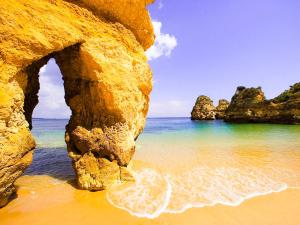 an arch in the rocks on the beach at Algarpraia in Carvoeiro