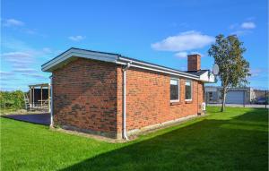a red brick house with a grass yard at Gorgeous Home In Egå With Wifi in Egå