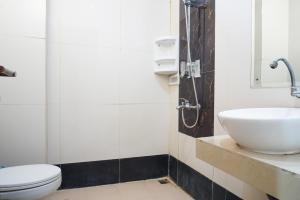 a bathroom with a sink and a toilet at RedDoorz near Kemang Square in Jakarta +17 photos