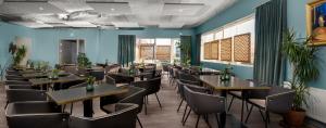 un restaurante con mesas y sillas en una sala con paredes azules en ODDSSON Hotel, en Reikiavik