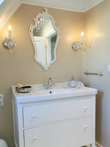 a bathroom with a white sink and a mirror at Spilburg Apartments in Wetzlar