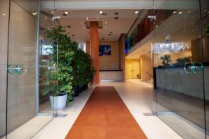 a hallway with potted plants in a building at Lacoba Hotel in Athens