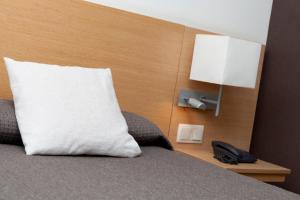 Postel nebo postele na pokoji v ubytování Hotel Sagrada Familia