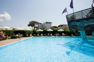 a swimming pool with a pool table and chairs at Hotel Poseidon in Terracina