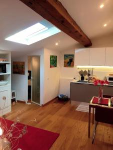 a kitchen and living room with a skylight at Loft Bianco in Florence