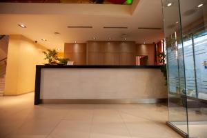 a lobby with a reception desk in a building at Lacoba Hotel in Athens