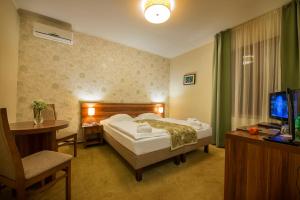 Postel nebo postele na pokoji v ubytování Wellness hotel Spark