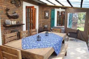 a patio with a table and chairs on a porch at Mickey Finn in Dullstroom
