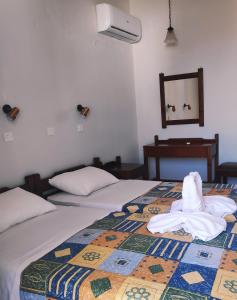 Habitación de hotel con 2 camas y toallas. en Ipanema Hotel en Tigaki