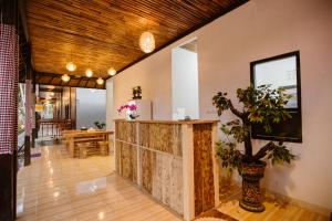 a lobby with a counter and a dining room at Double'D Hostel in Nusa Penida