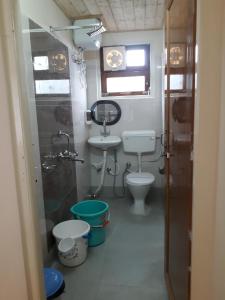 a small bathroom with a toilet and a sink at The River View Homestay in Kurseong