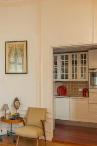 a kitchen with a chair and a table in a room at Veeve - Vintage & Eclectic in the 17th in Paris