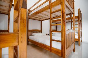 a bedroom with two bunk beds in a room at Double'D Hostel in Nusa Penida