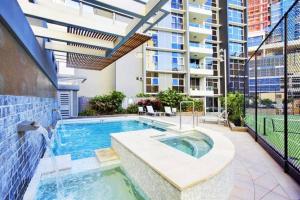 an indoor swimming pool with a building in the background at SK1 - 2 level 2 Bedroom Skyline SkyHome in Brisbane