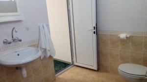 a bathroom with a shower and a toilet and a sink at Guest House Diamant in Sozopol
