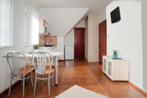 a kitchen and dining room with a table and chairs at Čerti Apartmány in Liberec