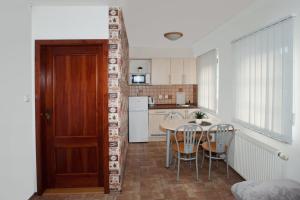 a kitchen and dining room with a table and chairs at Čerti Apartmány in Liberec