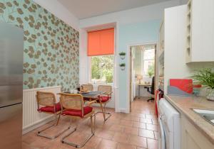 a kitchen with a table and chairs in a kitchen at The Lauderdale Street Residence in Edinburgh