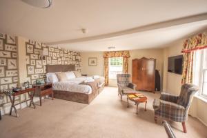 a bedroom with a bed and a table and chairs at Norfolk Arms Hotel in Arundel