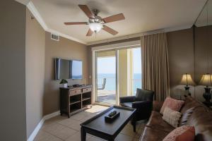 a living room with a couch and a ceiling fan at Grand Panama 1-1201 3-bed in Panama City Beach
