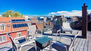 a group of chairs sitting on top of a balcony at Premium Apartments by Livingdowntown in Zürich