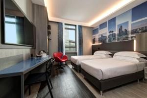 a hotel room with two beds and a desk at iQ Hotel Milano in Milan +65 photos