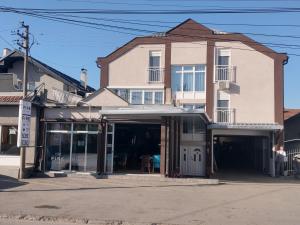 a building with an open garage in front at Fine Suites in Niš