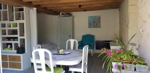 a dining room with a table and chairs at 21 Les Boissières in Saint-Branchs