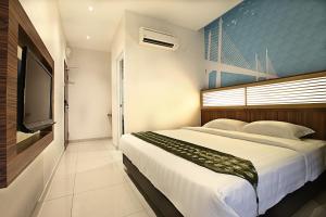 1 dormitorio con 1 cama grande y TV en Sri Enstek Hotel KLIA, KLIA 2 & F1, en Sepang