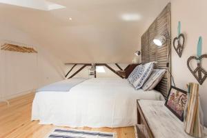 a bedroom with a large white bed and a table at Lisbon Avenida Apartment in Lisbon