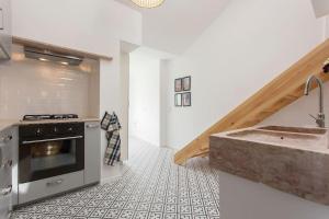 a kitchen with a sink and a stove at Lisbon Avenida Apartment in Lisbon