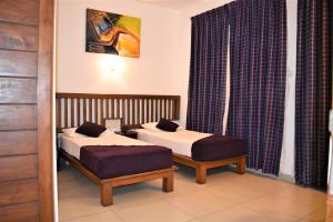 A bed or beds in a room at Port View City Hotel