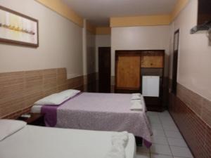 מיטה או מיטות בחדר ב-Hotel Pousada Paraíso das Águas