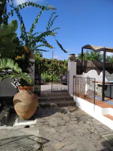 a balcony with a gate and a vase with plants at Residence Al Mare in Vulcano