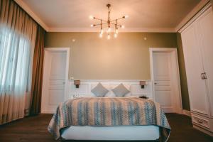 a bedroom with a bed and a chandelier at Rodosto Hotel in Tekirdağ