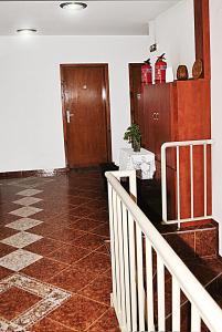 a room with a hallway with a staircase and a door at Family hotel Zora in Sofia
