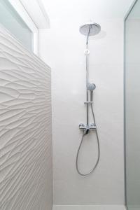 a shower with a shower head in a bathroom at Anna in Zagreb